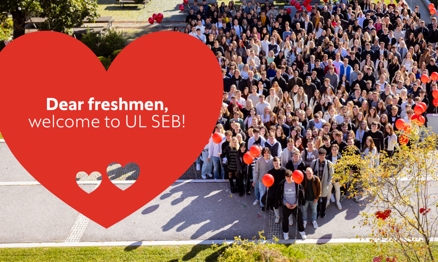 A group of people stands in front of a heart, welcoming freshmen to UL SEB.