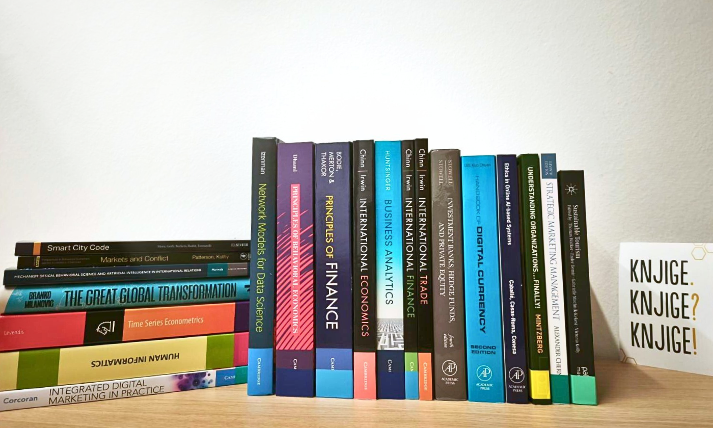 A shelf of new academic books on economics, finance, management and digital marketing at the CEK Library, predominantly published by Cambridge University Press.
