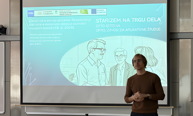 Moški stoji pred projekcijskim zaslonom, na katerem so prikazane informacije o projektu z naslovom »Starizem na trgu dela« v slovenščini, z ilustracijami ljudi in logotipi.
