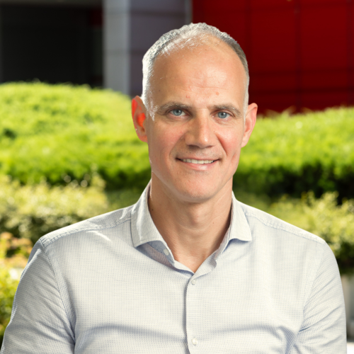Business portrait of Aleš Berk Skok in the green atrium of the School of Economics and Business on a sunny day